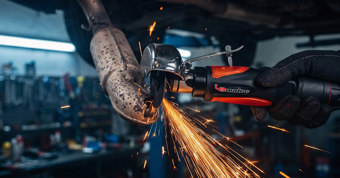 A Le Lematec pneumatic cutoff tool cutting a rusted car exhaust pipe and creating a bright spray of sparks.