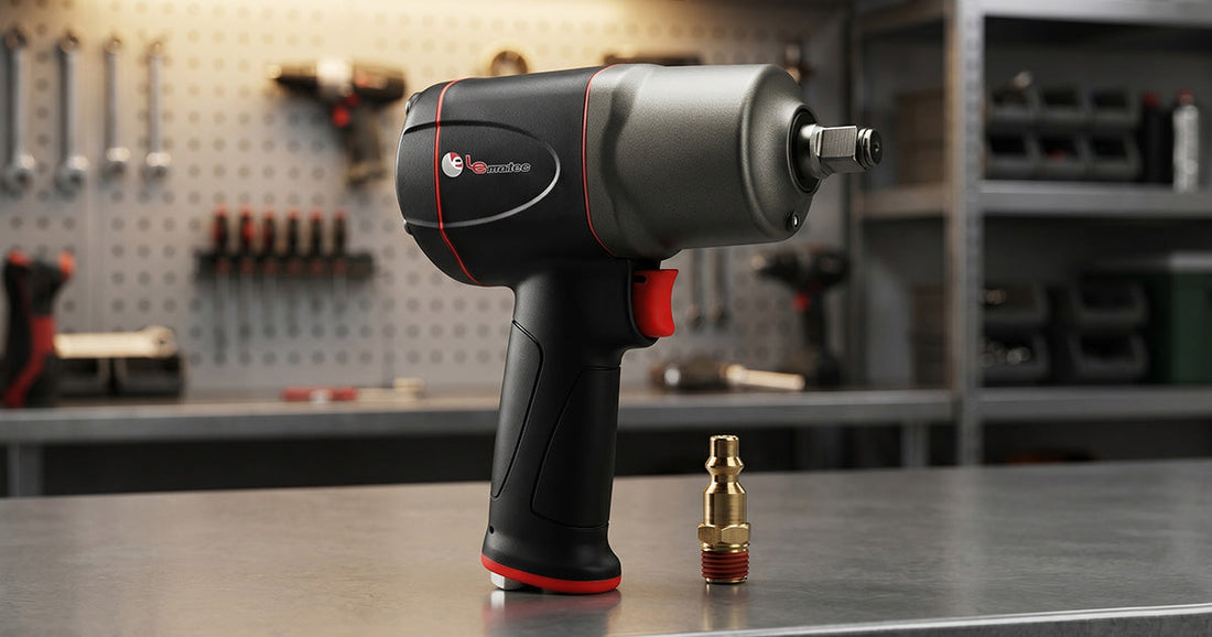 High-torque professional pneumatic impact wrench with a brass air fitting on an industrial-grade steel workbench.