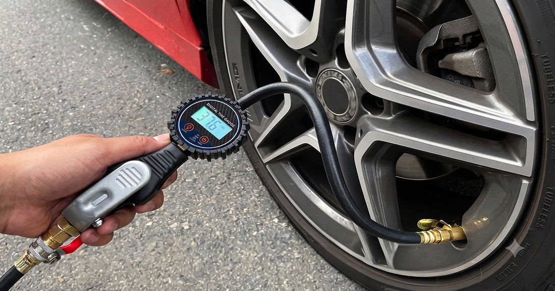 Digital pneumatic tire inflator gauge checking air pressure on a car wheel at a service station.