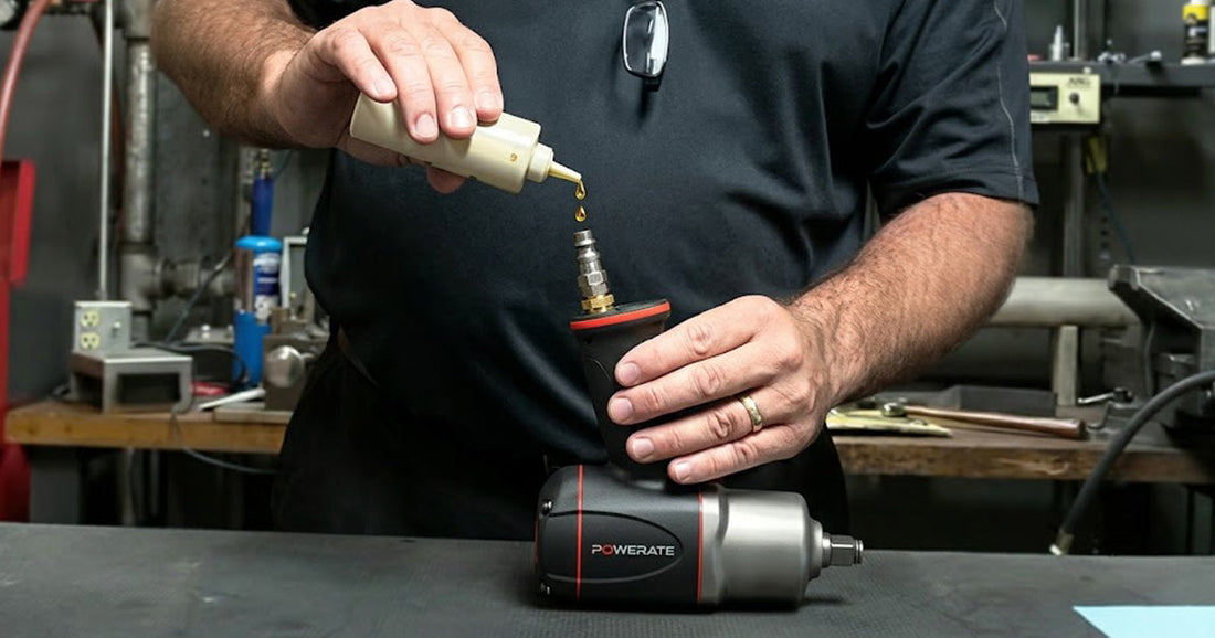 Technician applying pneumatic tool oil to an impact wrench inlet to extend tool life and prevent damage.