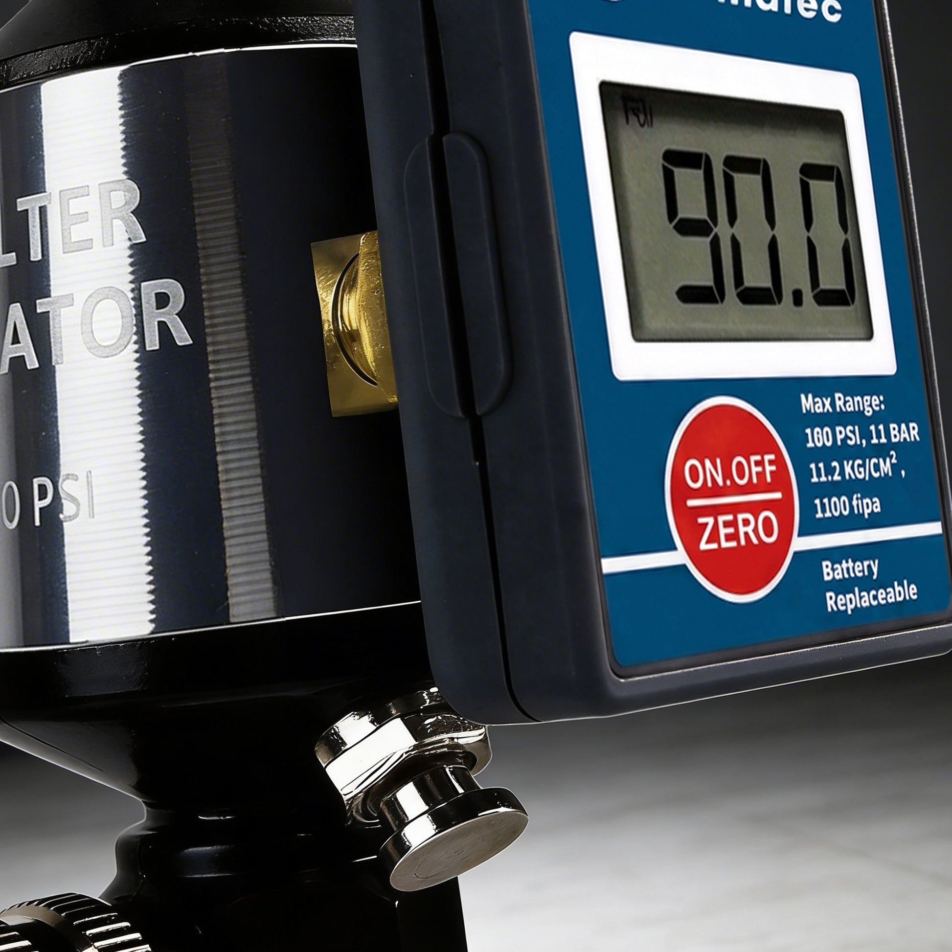 Close-up of the AI303-R2 digital display reading 90.0 PSI above the knurled push-button drain knob